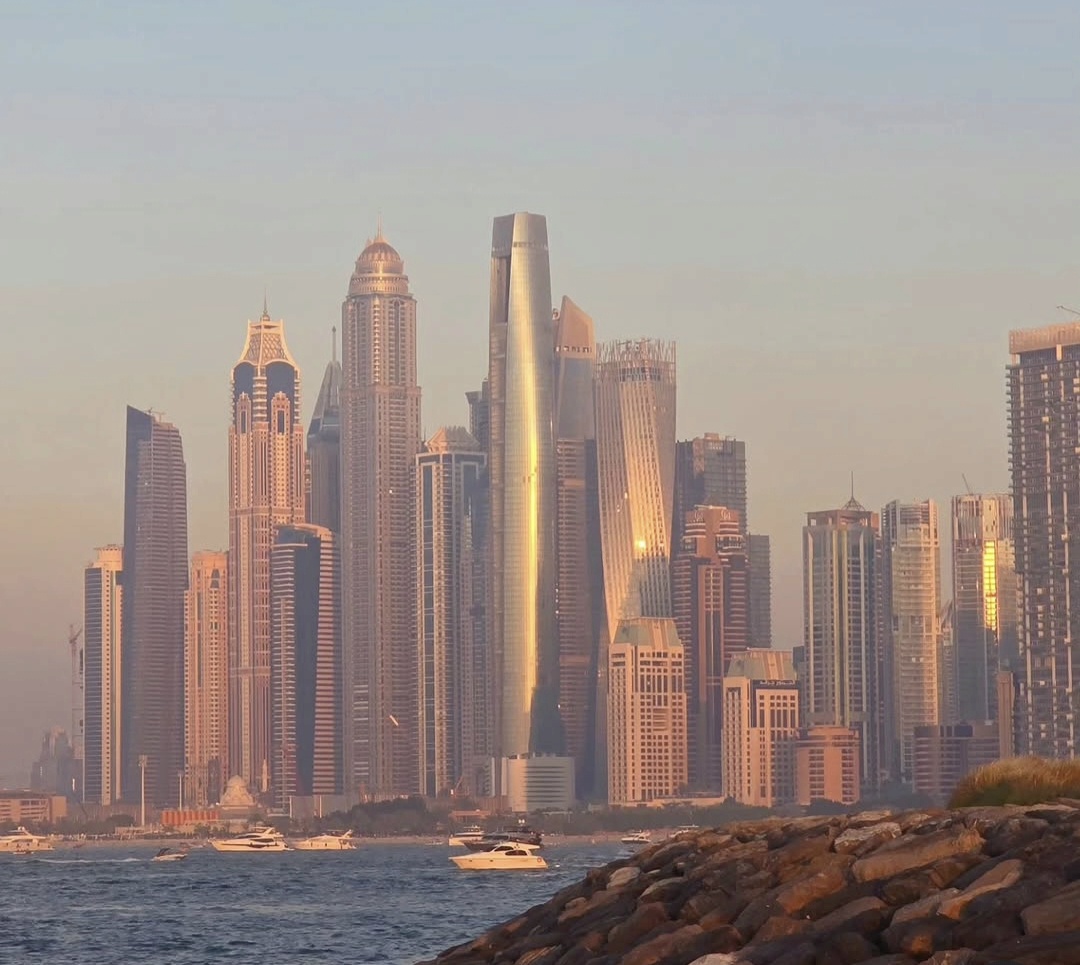 Dubai skyline in evening light with boats along the waterfront
