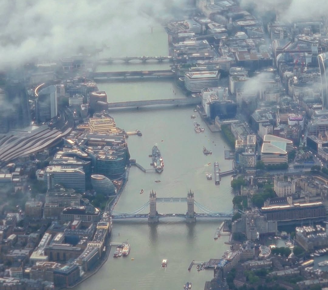 Aerial view of Tower Bridge and the River Thames through clouds