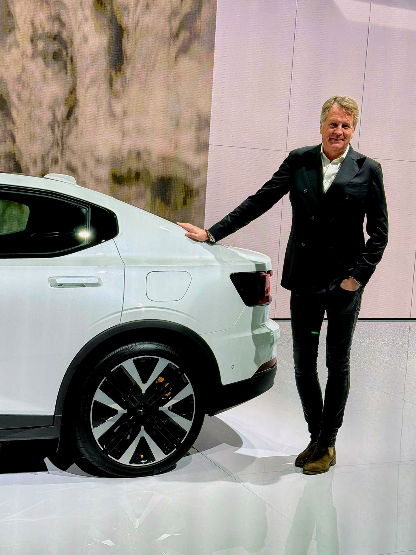 Lars Carlstrom standing beside a white Polestar car